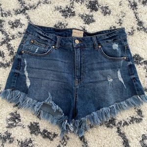 Woman’s frayed cut off jean shorts